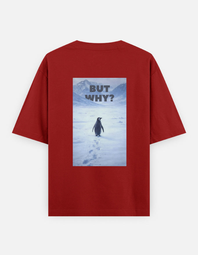 Back view of a red t-shirt featuring a rectangular graphic of a lone penguin walking across a snowy Antarctic landscape toward mountains with the text "BUT WHY?" in bold grey letters.