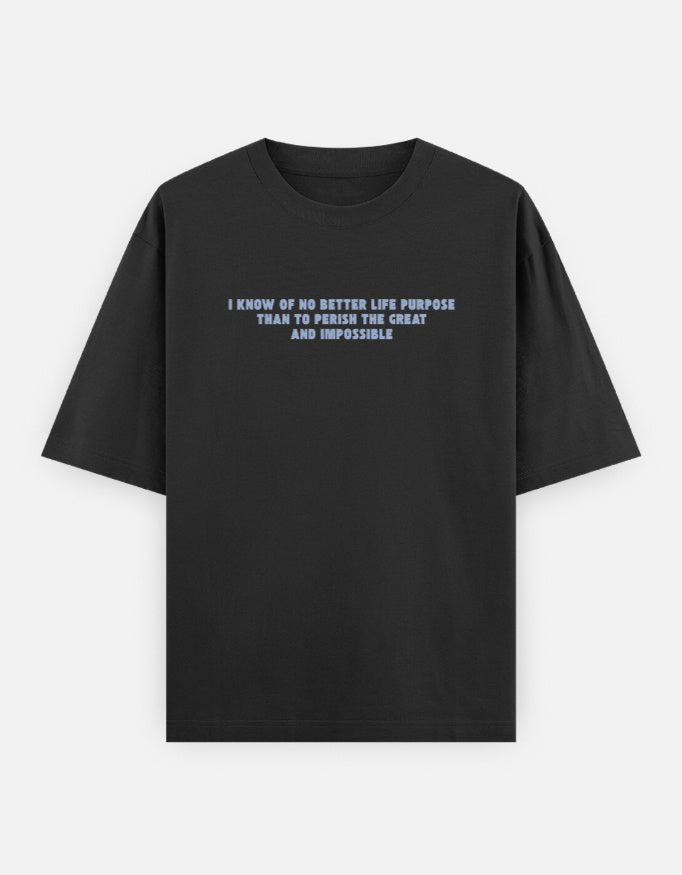 Front view of a black oversized t-shirt featuring the quote "I know of no better life purpose than to perish the great and impossible" printed in grey block letters across the chest.