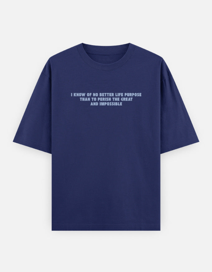 Front view of a blue oversized t-shirt featuring the quote "I know of no better life purpose than to perish the great and impossible" printed in grey block letters across the chest.