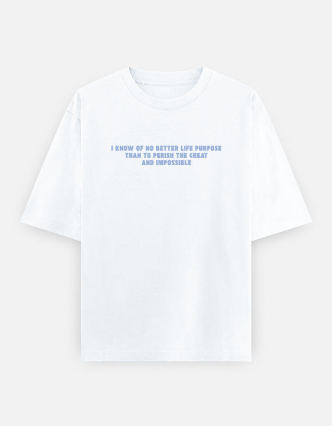 Front view of a white oversized t-shirt featuring the quote "I know of no better life purpose than to perish the great and impossible" printed in grey block letters across the chest.
