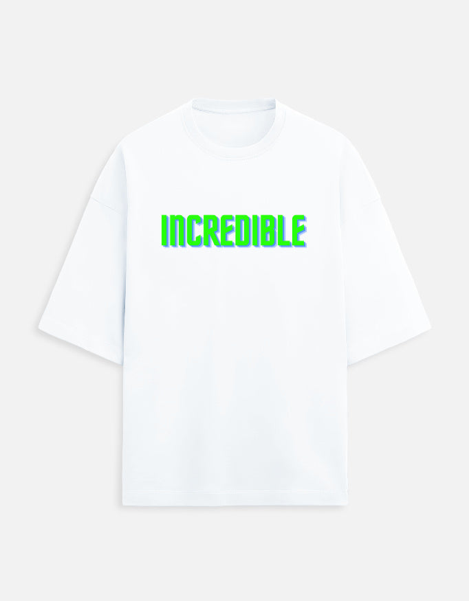 Front view of a white t-shirt with the word INCREDIBLE printed in 3D neon green and blue block letters.